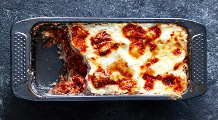Loaf tin lasagne with a portion taken out
