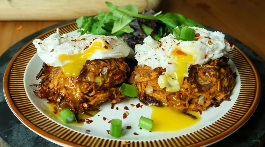 Crispy sweet potato rostis topped with poached eggs and chilli flakes