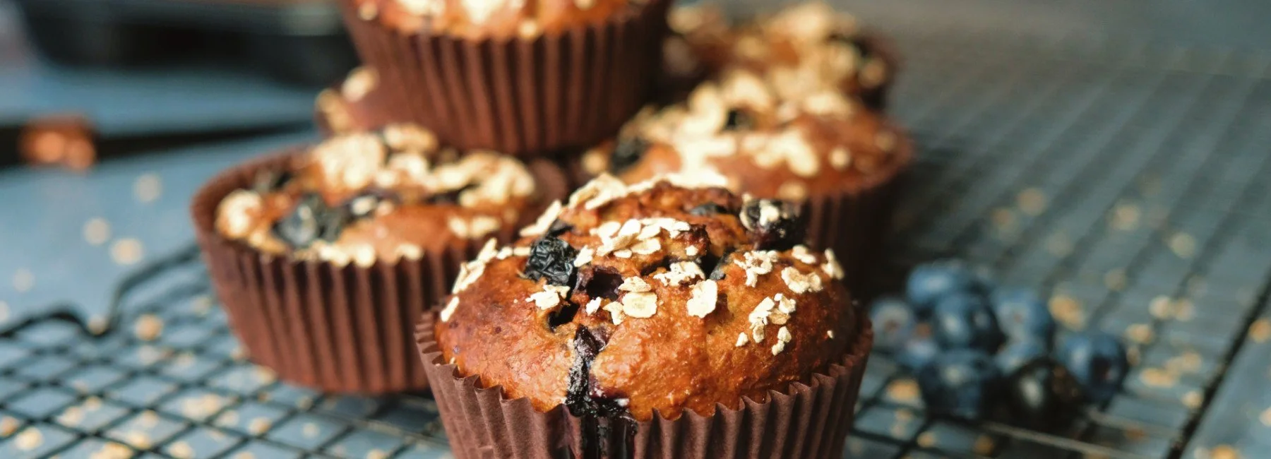 Blueberry oat protein muffins on a cooling rack