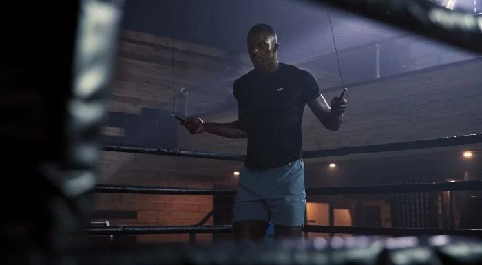 Man skipping with a rope in a boxing gym