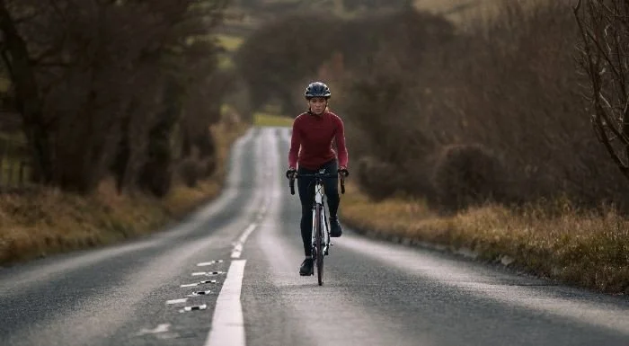 Cyclist riding along a country road