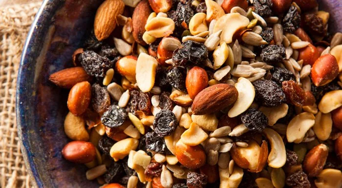 Bowl of trail mix with nuts, raisins and seeds