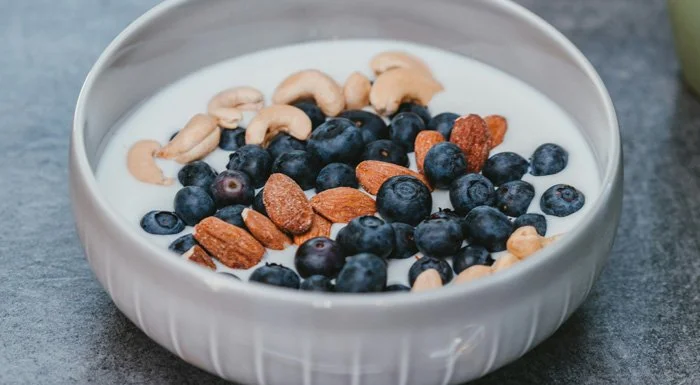 Bowl of yoghurt with blueberries, almonds and cashews