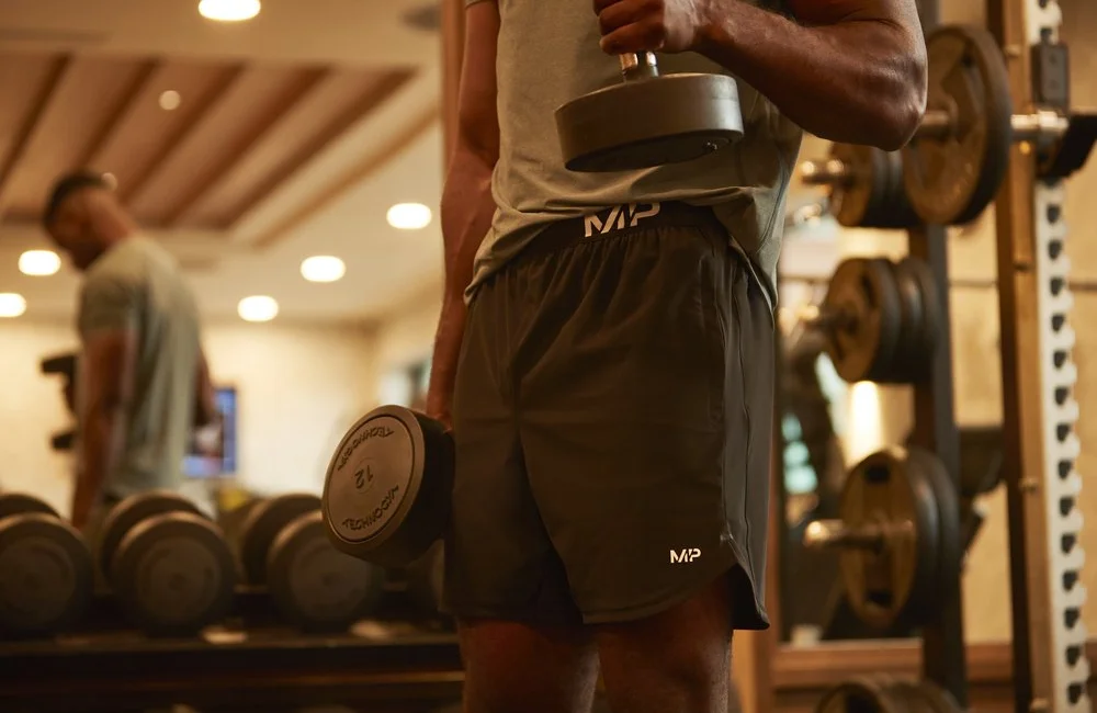 New boxing training clothing from Myprotein, featuring a man lifting dumbbells.