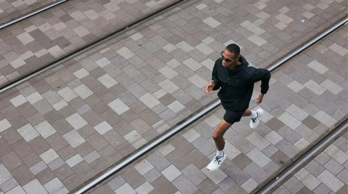 Man running across a paved square, seen from above