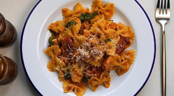 Plate of marry me chicken pasta topped with grated cheese