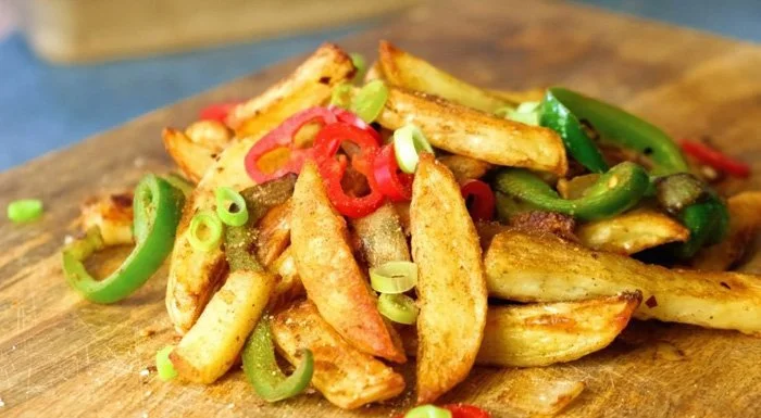 Salt and pepper chips with sliced chillies and spring onions