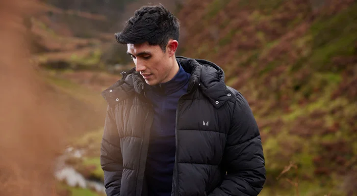 Man in a Myprotein puffer jacket walking in the countryside