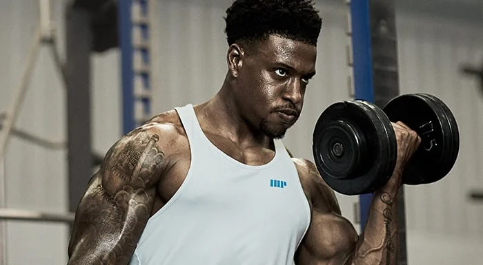 Man doing a dumbbell curl in the gym