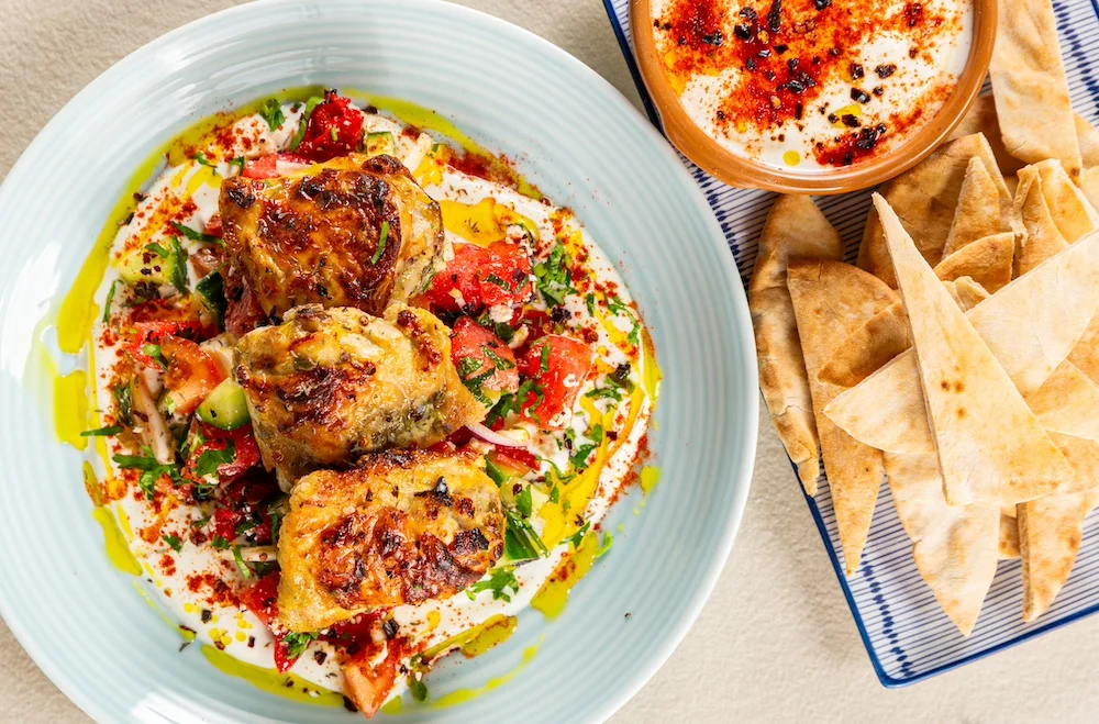Chicken and tzatziki topped with tomato and cucumber salsa and a drizzle of olive oil.
