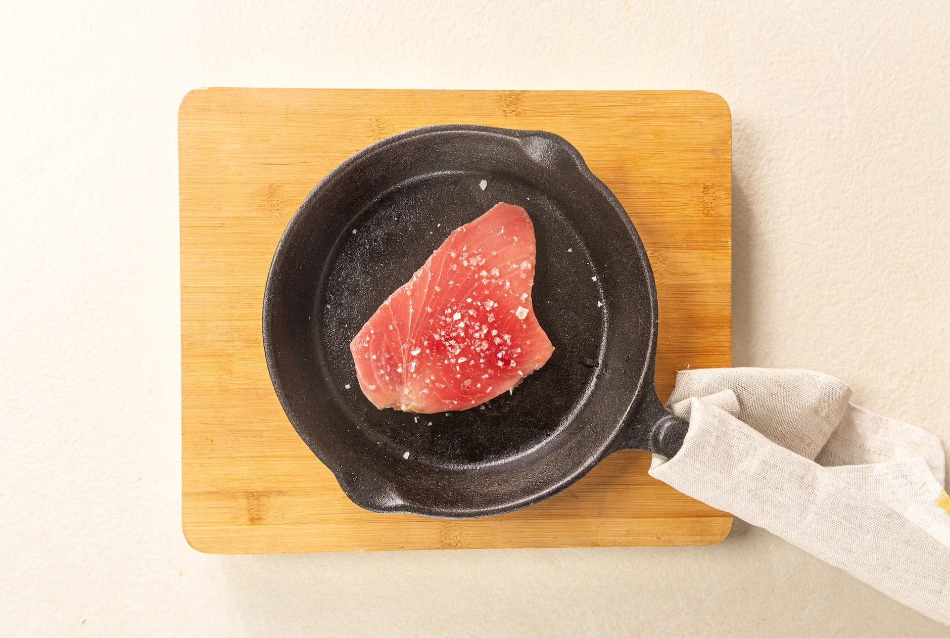 Raw tuna steak in a pan.