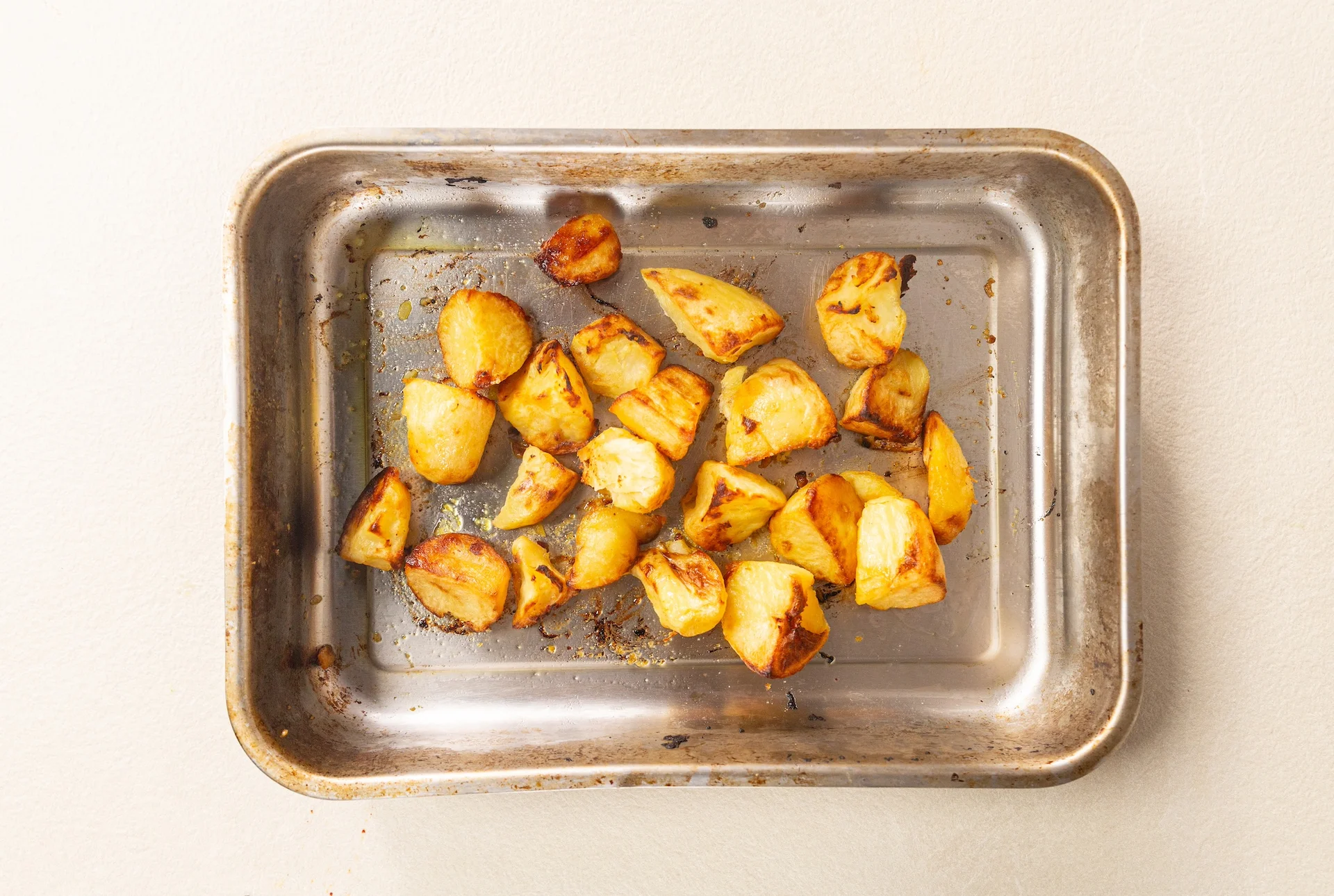 Roasted miso potatoes on a lined metal tray out of the oven.