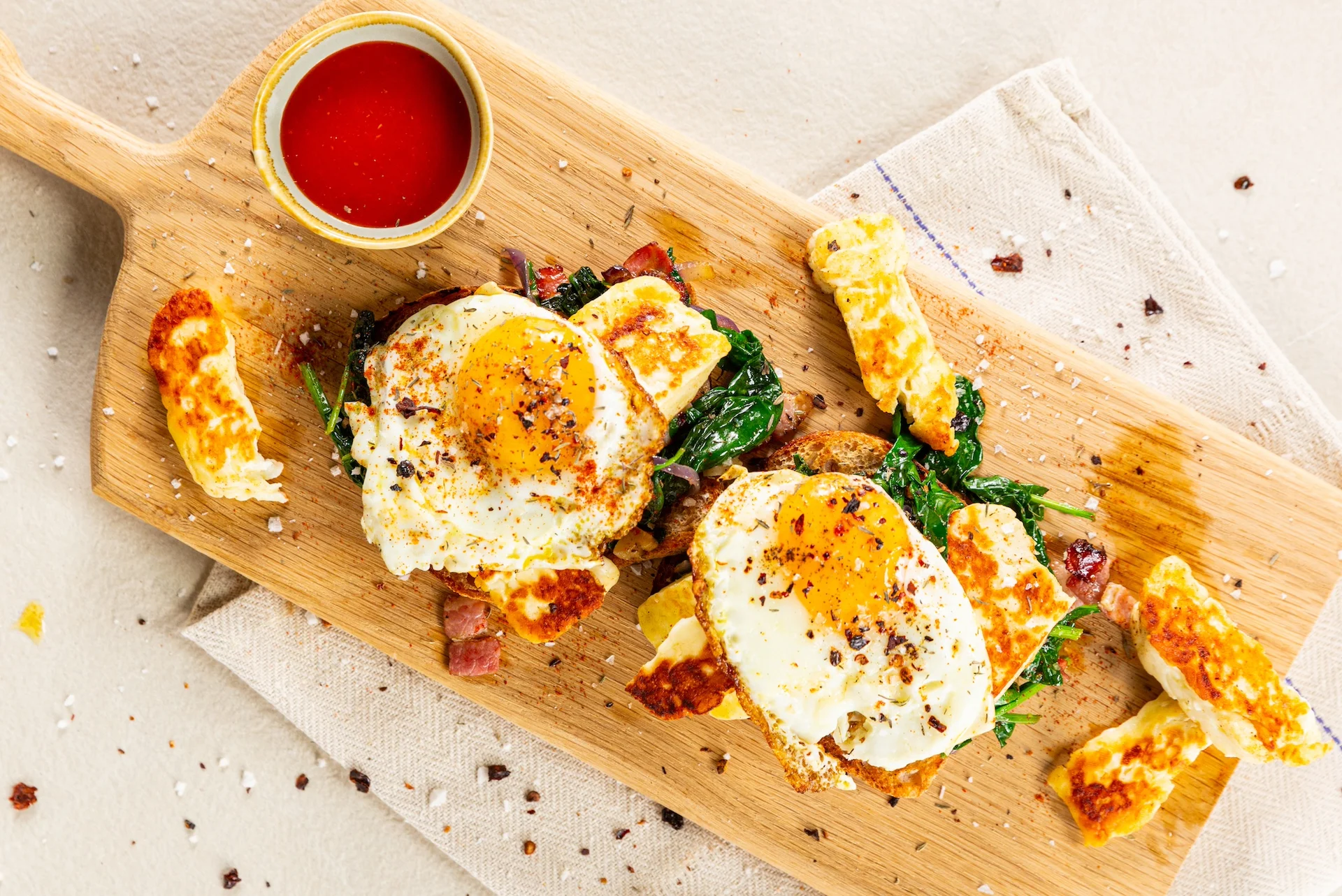 Photo of eggs, bacon and spinach on toast.