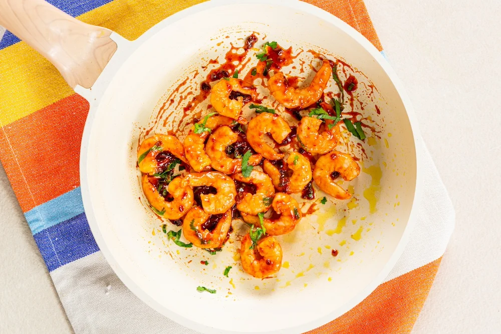 A pan with chipotle-coated prawns.