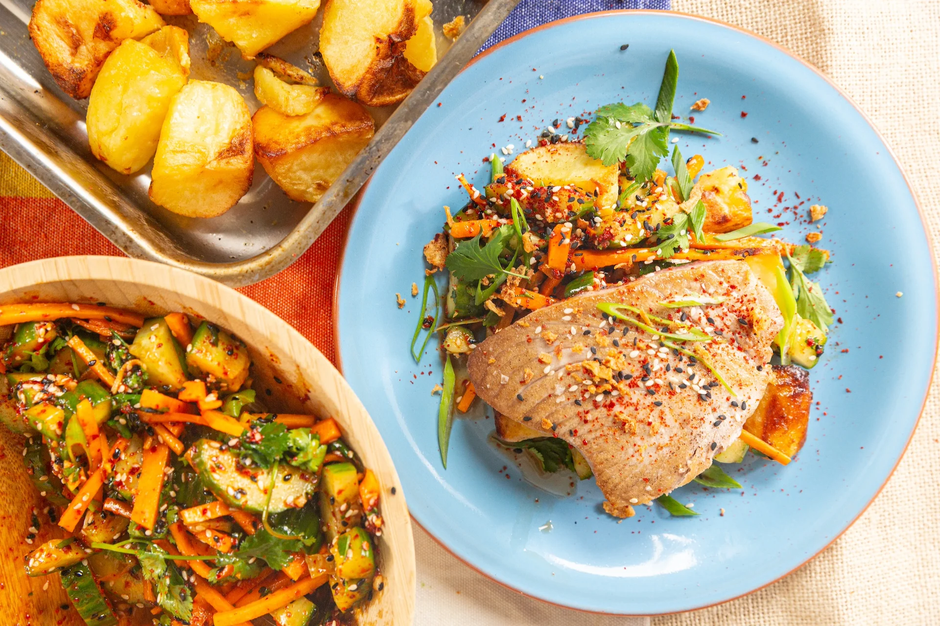 Tuna steak with salad and roasted potatoes.